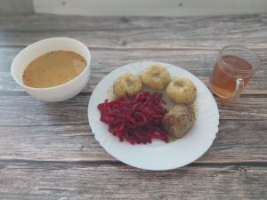 Zdjęcie przedstawia Dietę podstawową: Zupa grochowa z ziemniakami Kluski śląskie  Zrazik wieprzowy pieczony  Sos koperkowy dieta Sałatka z buraków i jabłka Kompot owocowy z jabłkami